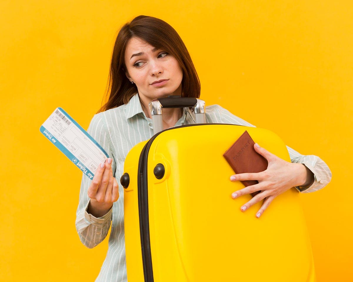 Shopper holding bags against a yellow background, representing consumer behaviour and changing prices.